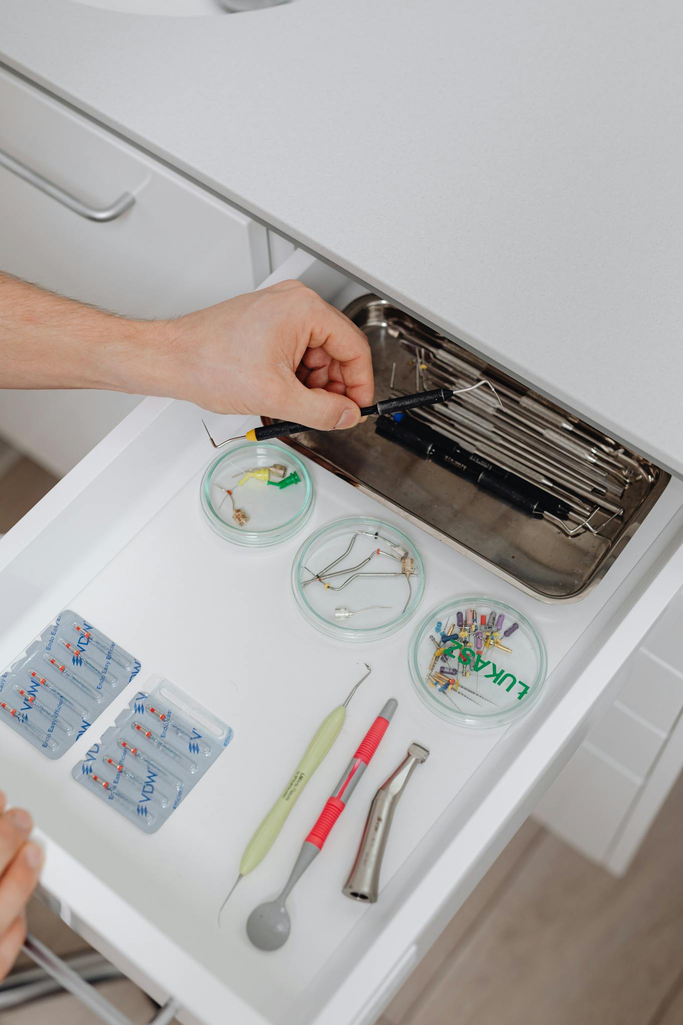 A close-up of dental instruments organized neatly in a drawer, ready for use.