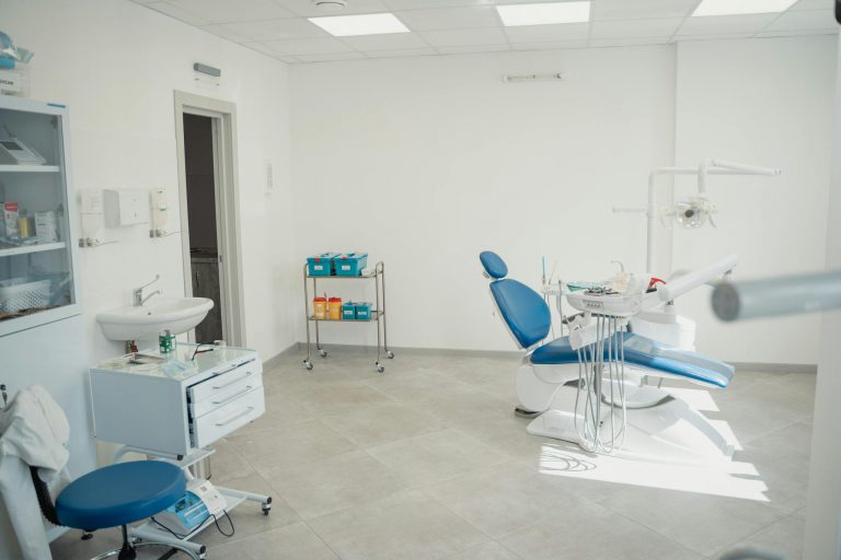 Bright and clean dental clinic interior showcasing a dental chair and equipment.