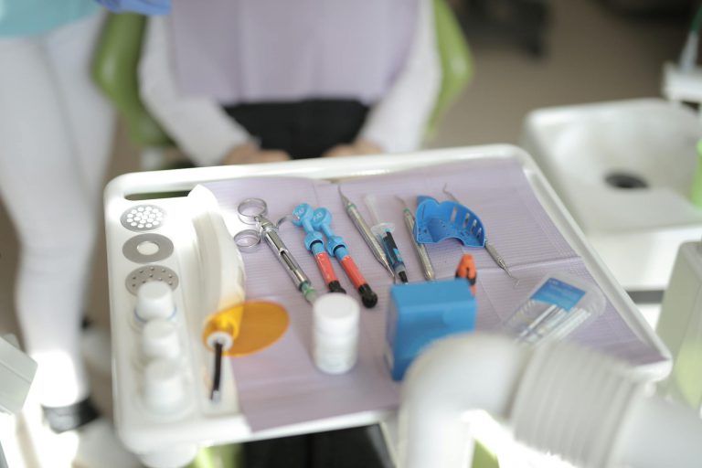 Close-up of various dental tools on an equipment tray in a modern clinic.
